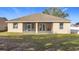 Exterior view of the house, highlighting the screened-in patio and backyard at 603 Deauville Ct, Kissimmee, FL 34758
