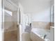 Bright bathroom with soaking tub and glass enclosed shower at 603 Deauville Ct, Kissimmee, FL 34758