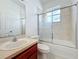 Bathroom features a tub/shower combo with glass doors, a vanity and mirror at 603 Deauville Ct, Kissimmee, FL 34758