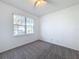 Carpeted bedroom with ceiling fan and view of the neighborhood at 603 Deauville Ct, Kissimmee, FL 34758