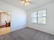 Bedroom features a ceiling fan and view into the dining room at 603 Deauville Ct, Kissimmee, FL 34758