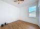 Empty bedroom features wood-look flooring, a ceiling fan, and a window at 603 Deauville Ct, Kissimmee, FL 34758