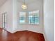 Bright dining area features two windows, wood floors and white trim and walls at 603 Deauville Ct, Kissimmee, FL 34758