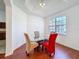 Dining area with modern glass table, colorful chairs, and bright window at 603 Deauville Ct, Kissimmee, FL 34758
