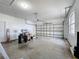 Spacious garage with white walls and a large garage door at 603 Deauville Ct, Kissimmee, FL 34758