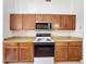 Kitchen with ample wooden cabinets and modern appliances including microwave at 603 Deauville Ct, Kissimmee, FL 34758