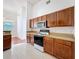 Kitchen features ample wooden cabinets and modern appliances and tile floor at 603 Deauville Ct, Kissimmee, FL 34758
