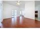 Living room with hardwood floors, ceiling fan, high ceilings and access to the kitchen and outdoor patio at 603 Deauville Ct, Kissimmee, FL 34758