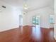 Bright living room with ceiling fan, hardwood floors, archway entry and patio access at 603 Deauville Ct, Kissimmee, FL 34758