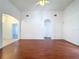 Bright open living room featuring hardwood floors, neutral walls, and archway entries at 603 Deauville Ct, Kissimmee, FL 34758