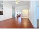 Open-concept living room with hardwood floors, ceiling fan, archway entry and neutral walls at 603 Deauville Ct, Kissimmee, FL 34758