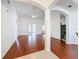 Spacious living room with hardwood floors, ceiling fan and archway entry to kitchen and french doors at 603 Deauville Ct, Kissimmee, FL 34758