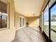 Screened patio with tile flooring, featuring access doors to the backyard at 603 Deauville Ct, Kissimmee, FL 34758