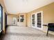 Screened patio with tile flooring, featuring access doors to the backyard at 603 Deauville Ct, Kissimmee, FL 34758