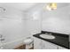 Clean bathroom featuring tiled shower, tiled floor, and large vanity at 627 N Hyer Ave, Orlando, FL 32803