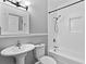 Bathroom featuring a white sink, toilet, and tub with shower at 627 N Hyer Ave, Orlando, FL 32803