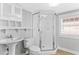 Clean bathroom with glass shower, white tile, and modern fixtures at 627 N Hyer Ave, Orlando, FL 32803