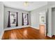 Bedroom featuring hardwood floors and windows with purple curtains at 627 N Hyer Ave, Orlando, FL 32803