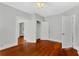 Bright bedroom features hardwood floors, closet, and doors to adjacent rooms at 627 N Hyer Ave, Orlando, FL 32803