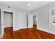 Spacious bedroom featuring refinished hardwood floors, fresh neutral paint, and ample natural light at 627 N Hyer Ave, Orlando, FL 32803