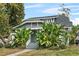 Charming home featuring a lush garden and beautiful architectural details at 627 N Hyer Ave, Orlando, FL 32803