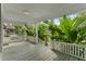 Inviting covered porch with white railing and tropical foliage at 627 N Hyer Ave, Orlando, FL 32803