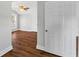 Hallway with hardwood floors leading to rooms, providing seamless flow at 627 N Hyer Ave, Orlando, FL 32803