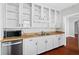 Kitchen with stainless dishwasher, white cabinets, and butcher block counters at 627 N Hyer Ave, Orlando, FL 32803