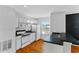 This modern kitchen features white cabinetry, stainless steel appliances, and hardwood floors at 627 N Hyer Ave, Orlando, FL 32803