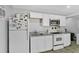 Kitchen with white appliances, countertop, and cabinets at 627 N Hyer Ave, Orlando, FL 32803