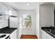 Bright kitchen with white cabinets and stainless steel sink; a lovely spot for cooking and creating at 627 N Hyer Ave, Orlando, FL 32803