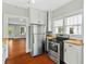 Clean kitchen features stainless steel appliances and wood floors at 627 N Hyer Ave, Orlando, FL 32803