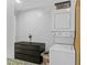 Bright laundry area features a stacked washer/dryer and dark storage cabinet at 627 N Hyer Ave, Orlando, FL 32803