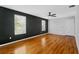 This living room boasts hardwood floors, a ceiling fan, and natural light from its oversized windows at 627 N Hyer Ave, Orlando, FL 32803