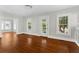 Bright living room with hardwood floors and a doorway leading to another room at 627 N Hyer Ave, Orlando, FL 32803