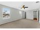 Bright main bedroom features carpet, a ceiling fan, and natural light from its windows at 627 N Hyer Ave, Orlando, FL 32803