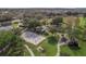 Aerial view of a sand volleyball court, playground, walking path, and picnic tables in a lush green community park at 7042 Buttonbush Loop, Harmony, FL 34773