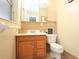 Charming bathroom with wooden vanity, tiled backsplash, and a toilet at 7119 Leighton Way, Orlando, FL 32822