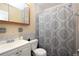 Compact bathroom with a gray tiled shower, white vanity, and classic fixtures at 7119 Leighton Way, Orlando, FL 32822
