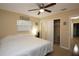 Comfortable bedroom with a ceiling fan, closet, and ample natural light at 7119 Leighton Way, Orlando, FL 32822