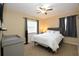 Comfortable bedroom with ceiling fan, carpet flooring, and windows with curtains at 7119 Leighton Way, Orlando, FL 32822