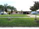 Charming single-story home featuring a well-maintained lawn, mature trees, and a covered front entry at 7119 Leighton Way, Orlando, FL 32822