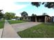 Single-story home with a covered carport and a brick-paved driveway leading up to the front entrance at 7119 Leighton Way, Orlando, FL 32822