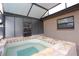 Close up of hot tub and access to screened-in lanai at 7119 Leighton Way, Orlando, FL 32822