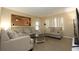 Inviting living room with comfortable seating, a large mirror, and a view of the backyard at 7119 Leighton Way, Orlando, FL 32822