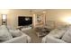 Spacious living room with neutral tones, comfortable seating, and a large television for entertaining at 7119 Leighton Way, Orlando, FL 32822
