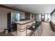 Enclosed patio featuring a tile bar with refrigerator and access to outdoors at 7119 Leighton Way, Orlando, FL 32822