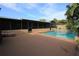 View of pool and screened-in lanai with access to pool, deck and lush backyard area at 7119 Leighton Way, Orlando, FL 32822