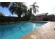 Backyard pool surrounded by stone feature and lush landscaping at 7119 Leighton Way, Orlando, FL 32822