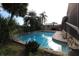 Backyard pool surrounded by lush landscaping and stone rock feature at 7119 Leighton Way, Orlando, FL 32822